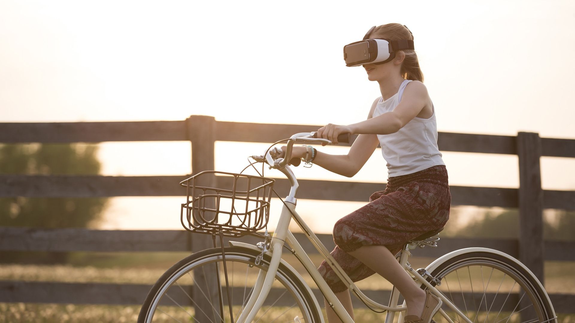 a woman rides a bicycle wearing vr-glasses.