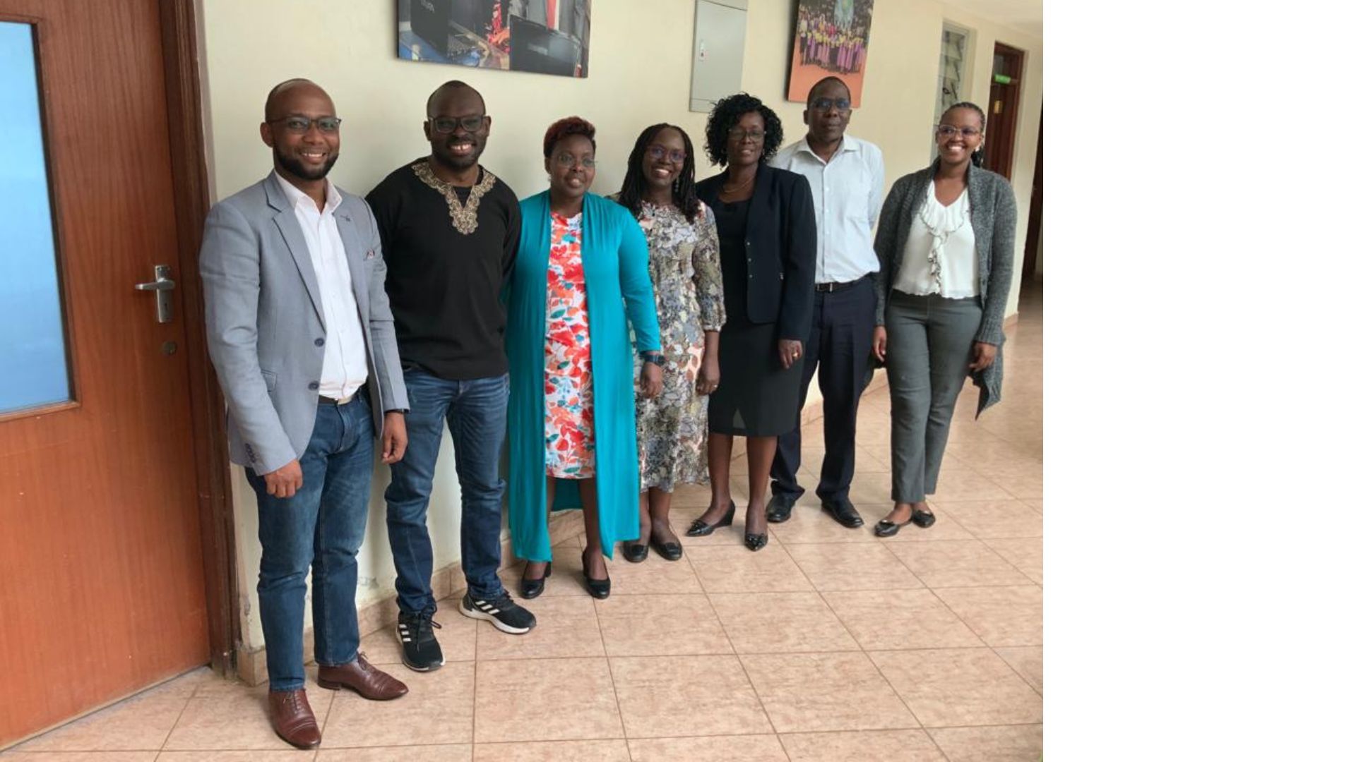 People from the research team and representatives from Fida International standing in a row and posing for the camera.