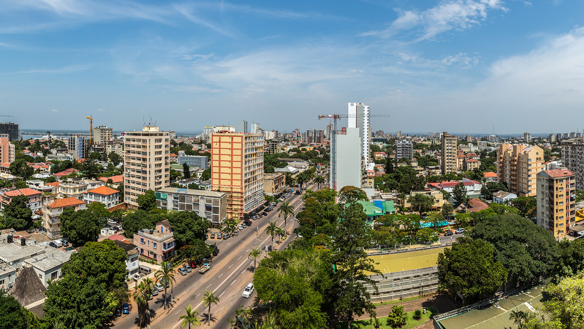 A view on Maputo city with high buildings and a wide street.