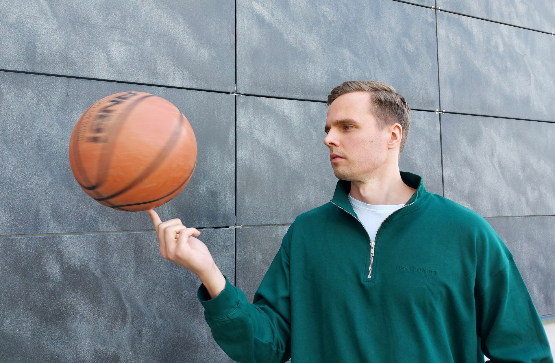 Henkilö pyörittää koripalloa.