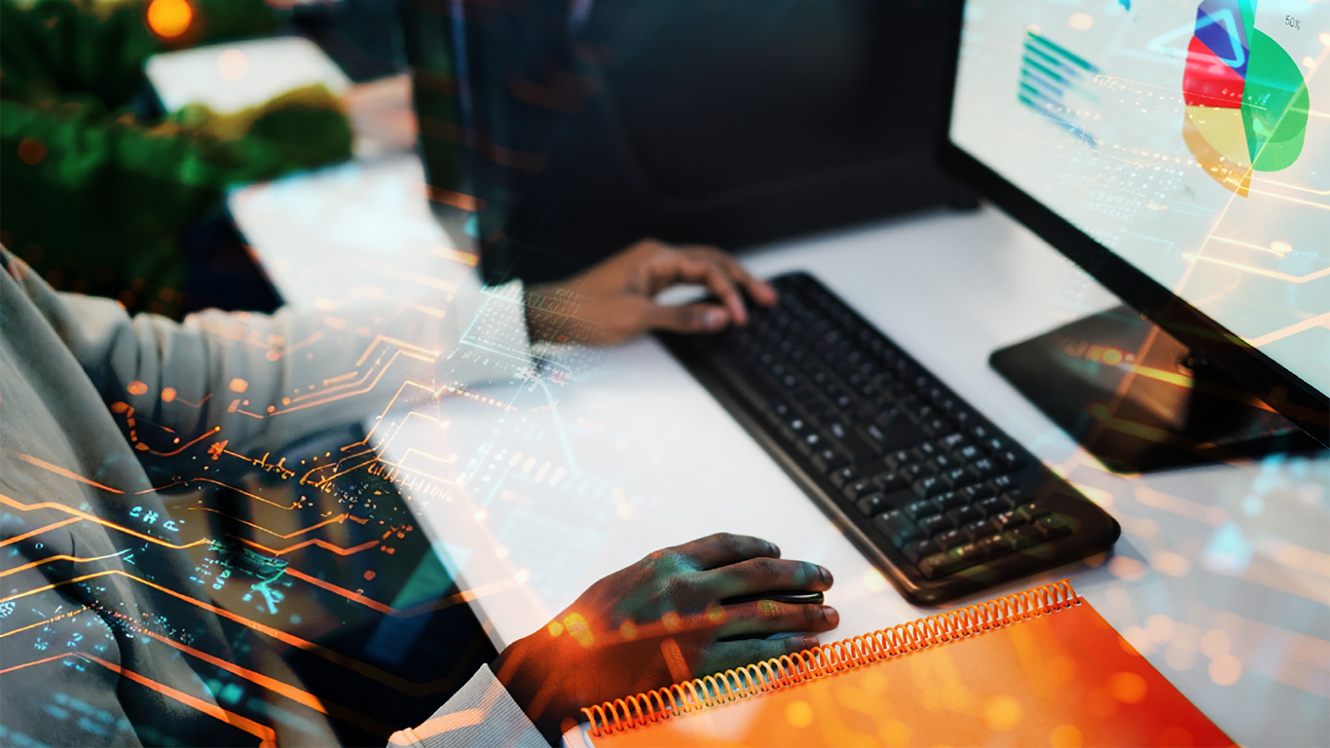 Students' hands on computer keyboard in computer class