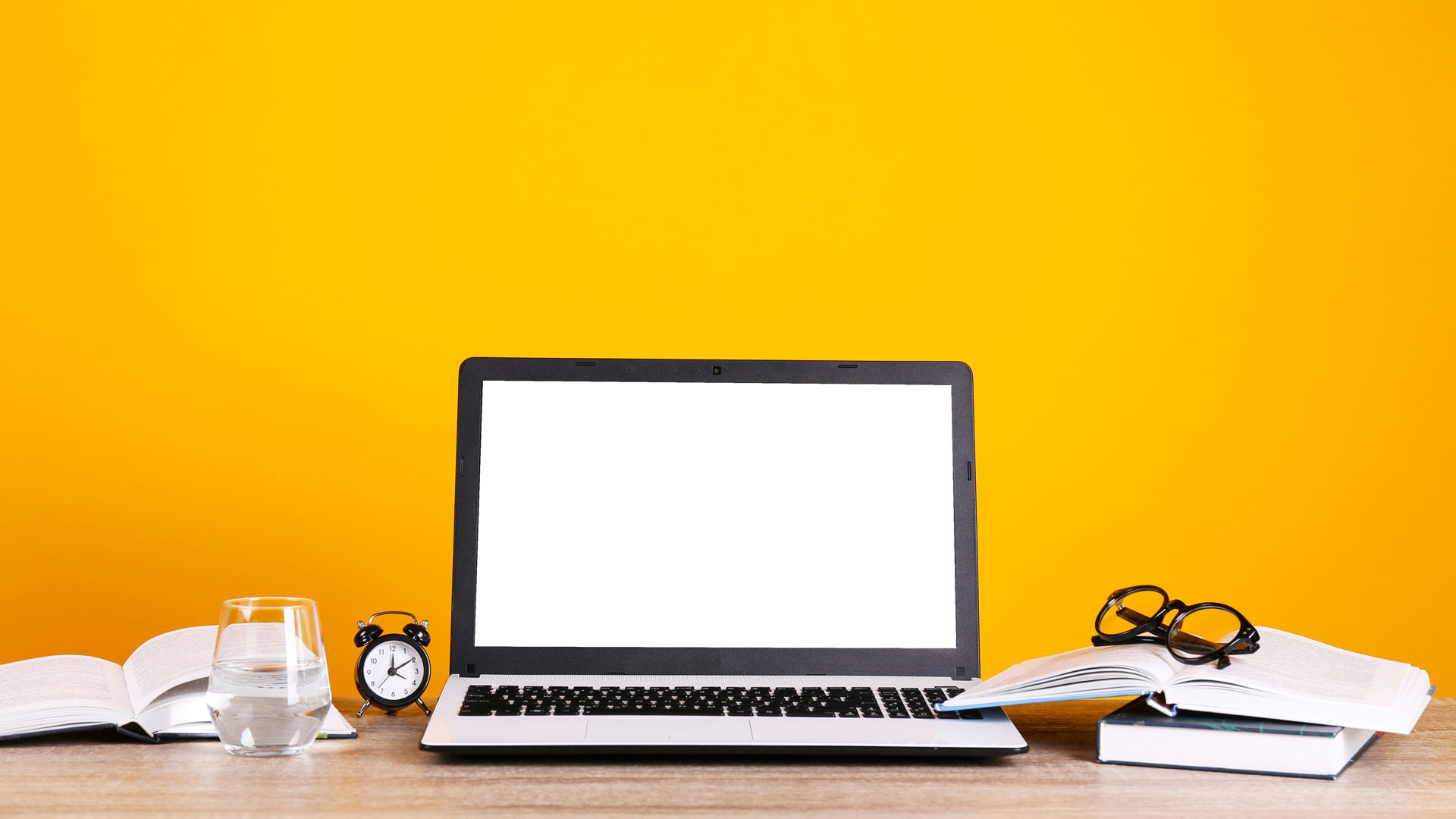 a desk with a laptop on it, yellow background