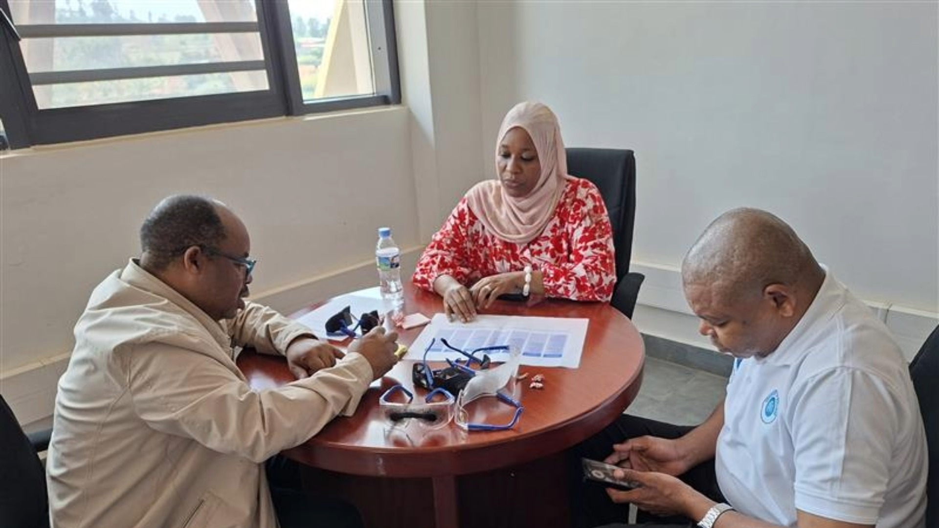 Three people working together in a room.
