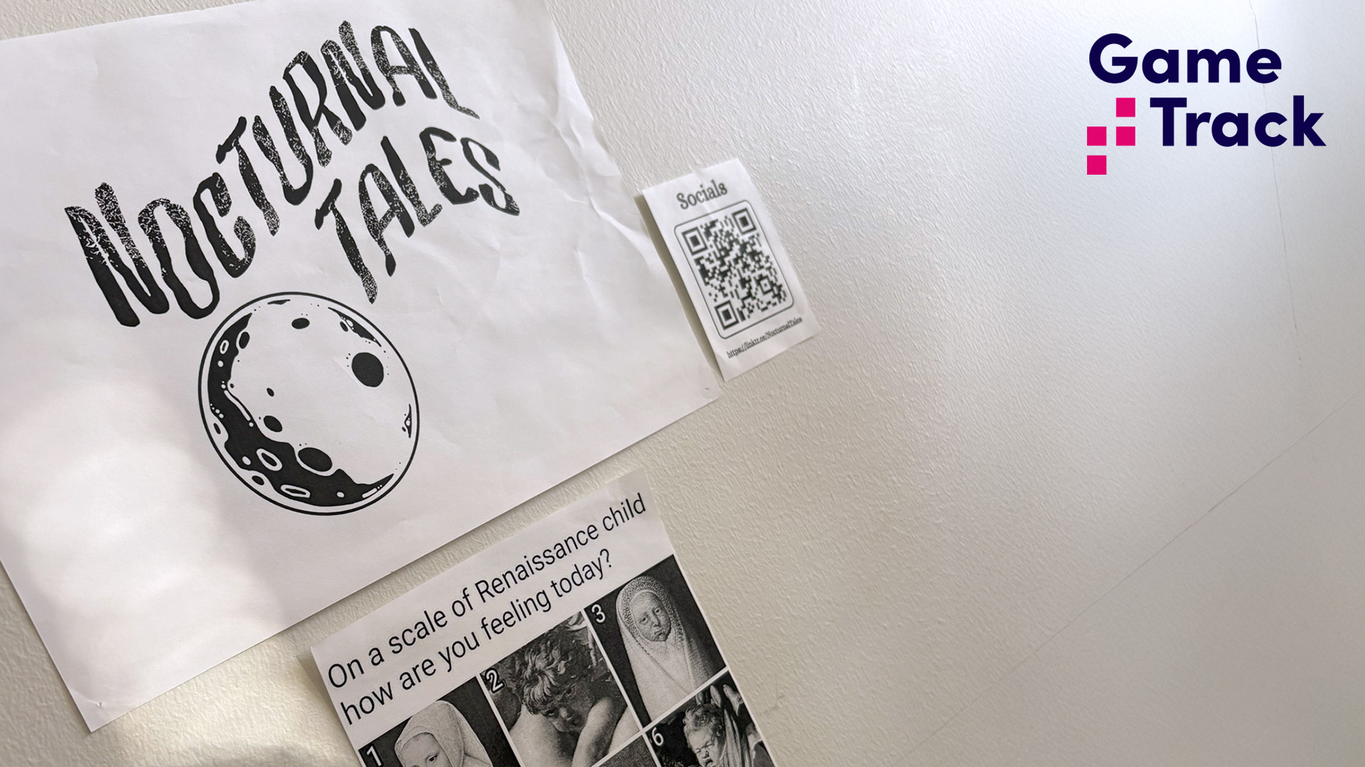 The logo of Nocturnal Tales game studio on a white office wall.