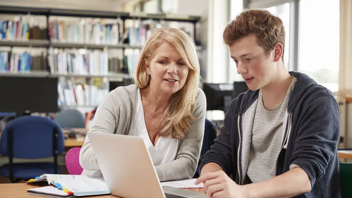 Tutor and a student sitting with a laptop