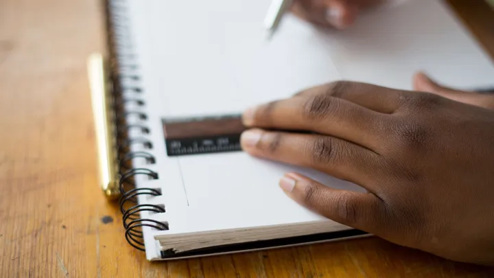 school student's hands holding a ruler on a notebook 
