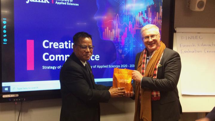 professor Bim Prasad Shrestha handing a present for Jamk&#039;s vice rector 
